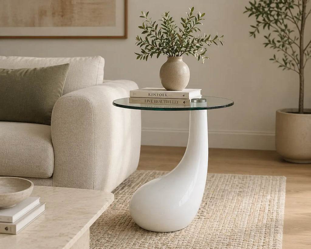 Table basse moderne avec plateau en verre rond et base sculpturale blanche, idéale pour salon contemporain élégant