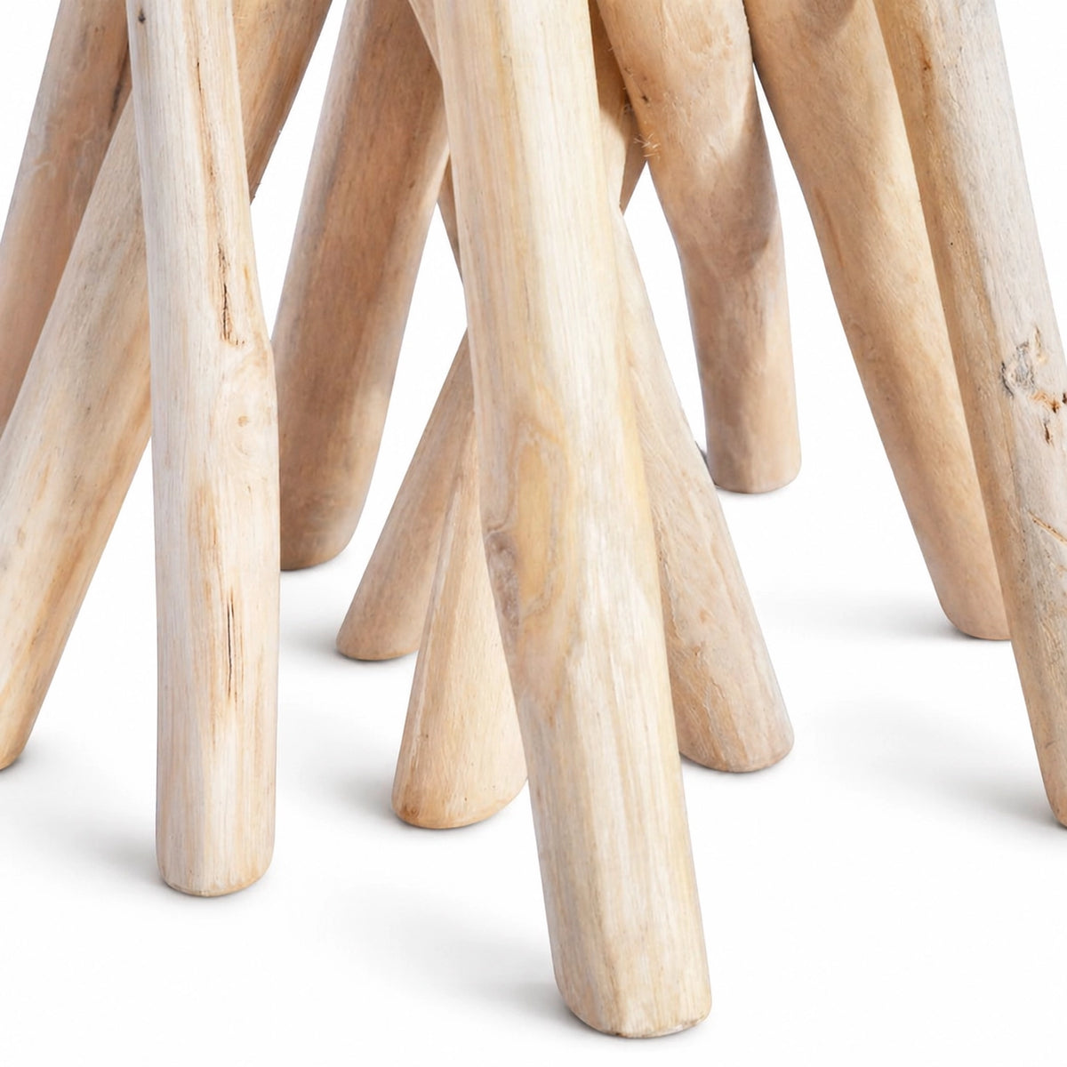 Gros plan sur la base en branches de bois naturel de la table d’appoint, mettant en valeur la texture organique du bois