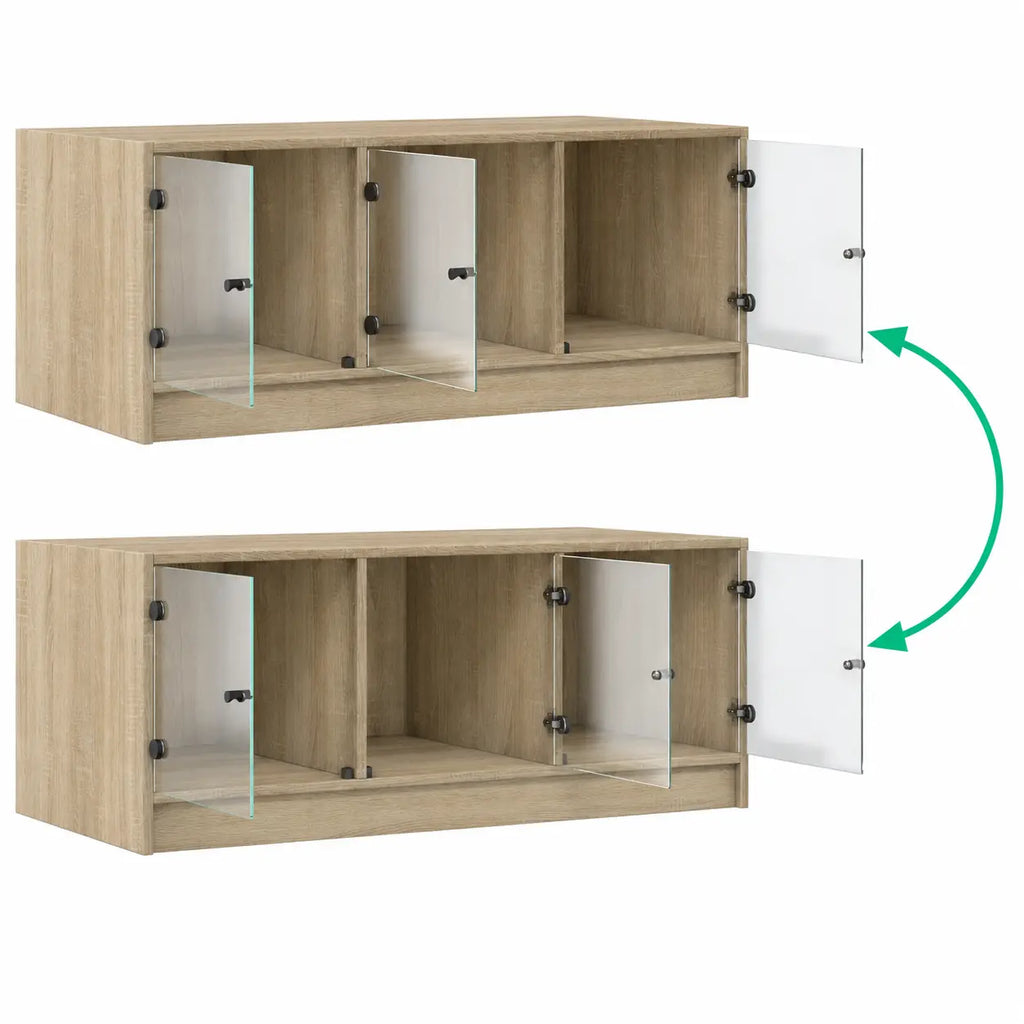Table basse en bois clair avec panneaux en verre pivotants, illustrant le système d’ouverture des compartiments de rangement